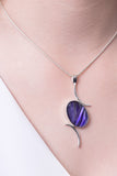 Model wearing Val B's Wax Sterling silver handcrafted pendant with purple cabochon hand-painted in wax  and sealed in glass