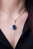 Model wearing Val B's Wax Sterling silver handcrafted pendant with blue cabochon hand-painted in wax  and sealed in glass