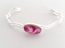 Beautiful Cerise wave bangle fully adjustable to fit the wearer handpainted in wax and sealed in glass 