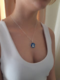 Model wearing a blue sterling silver Val B's Wax Woodland Owl Pendant 