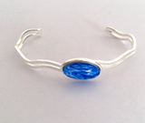 Brilliant blue fully adjustable wave bangle handpainted in wax and sealed in glass 